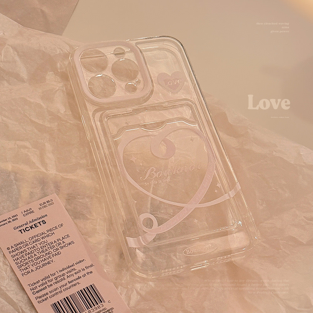 Clear iPhone case with heart and โbonjourโ design, featuring a small โLoveโ sticker, providing stylish and protective coverage.