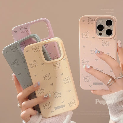 Pastel iPhone cases in pink and beige with a playful pattern of ribbons and dogs, offering stylish and protective coverage.