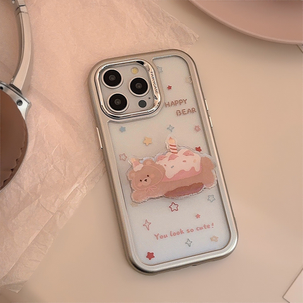 Happy Bear iPhone case with pastel design, featuring a cute bear on a dessert and a matching grip stand for convenience.